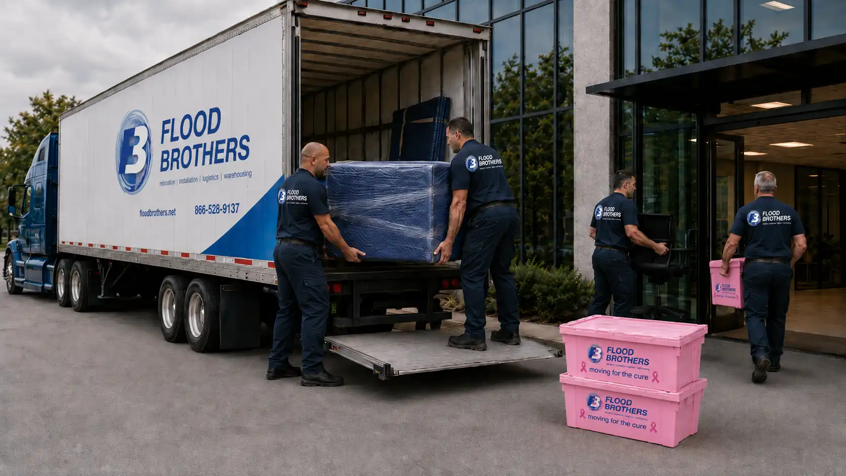 Commercial moving crew unloading boxes at an office building entrance