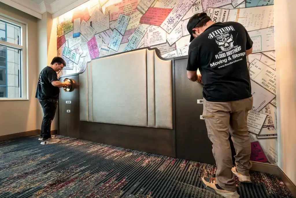 Flood Brothers white-glove crew installing FF&E casegoods with floor protection in place