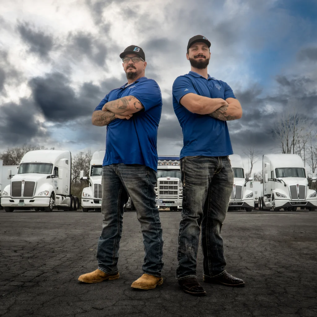 Robert and Michael Flood standing in front of the Flood Brothers fleet