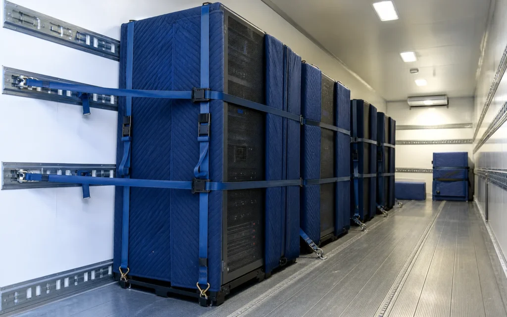Server equipment secured inside a climate-controlled Flood Brothers trailer at a Charlotte data center loading dock